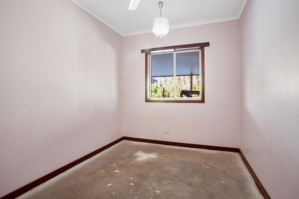 A room with pink walls and a window.