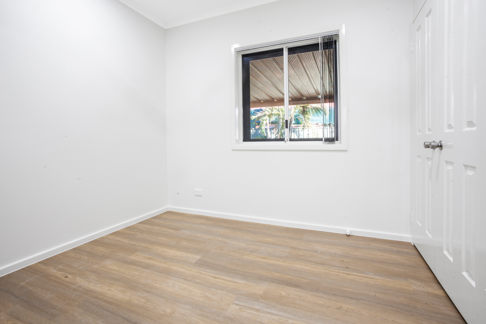 A room with a window and wooden floors