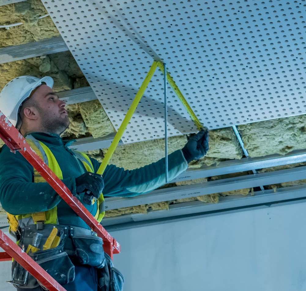 A man in safety gear is on the ladder