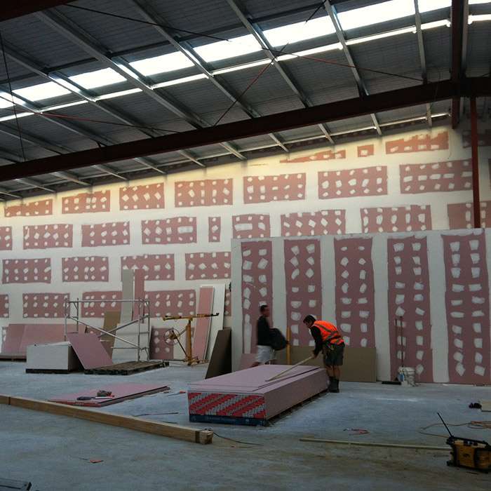 A man working in an industrial building with walls