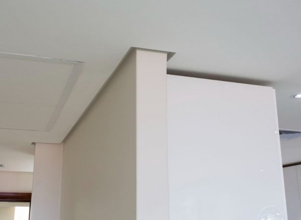 A corner of a room with white walls and ceiling.