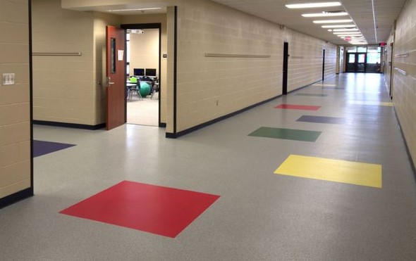 A hallway with many different colored squares on the floor.