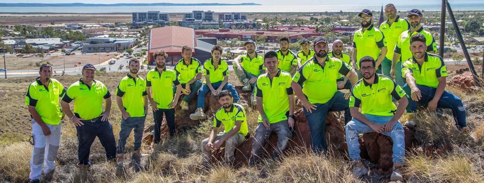 A group of people in yellow shirts and jeans.